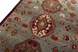 Backside of handmade 2000s Persian Gabbeh rug showing knot structure and weave density