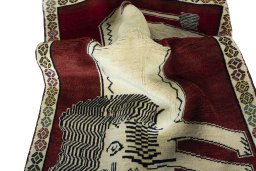 Corner detail of 2000s Persian Gabbeh rug showing border pattern and Wool pile