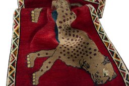 Corner detail of 2000s Persian Gabbeh rug showing border pattern and Wool pile