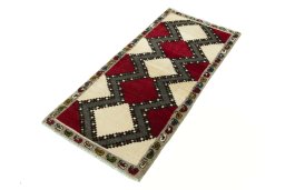 Corner detail of 2000s Persian Gabbeh rug showing border pattern and Wool pile