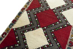 Backside of handmade 2000s Persian Gabbeh rug showing knot structure and weave density