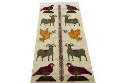Surface texture of 2000s Persian Gabbeh rug with natural Wool and intricate pattern