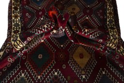 Corner detail of 2000s Persian Gabbeh rug showing border pattern and Wool pile