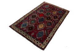 Corner detail of 2000s Persian Gabbeh rug showing border pattern and Wool pile