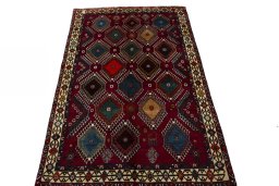 Surface texture of 2000s Persian Gabbeh rug with natural Wool and intricate pattern