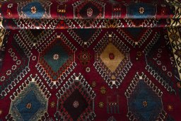 Full view of 2000s Persian Gabbeh rug from Iran / Persia, 235 × 146 cm in Red tones