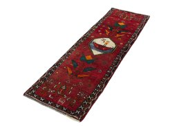 Corner detail of 2000s Persian Gabbeh rug showing border pattern and Wool pile