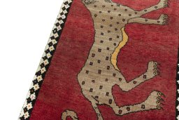Backside of handmade 2000s Persian Gabbeh rug showing knot structure and weave density