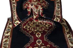 Corner detail of 2000s Persian Gabbeh rug showing border pattern and Wool pile