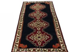 Surface texture of 2000s Persian Gabbeh rug with natural Wool and intricate pattern