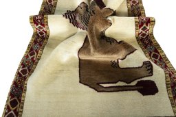 Corner detail of 2000s Persian Gabbeh rug showing border pattern and Wool pile
