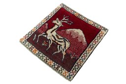Corner detail of 2000s Persian Gabbeh rug showing border pattern and Wool pile