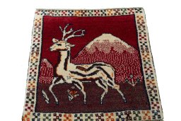Surface texture of 2000s Persian Gabbeh rug with natural Wool and intricate pattern
