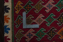 Backside of handmade 2000s Persian Gabbeh rug showing knot structure and weave density