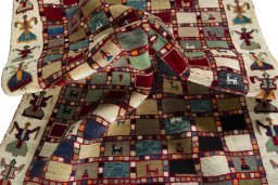 Corner detail of 2000s Persian Gabbeh rug showing border pattern and Wool pile