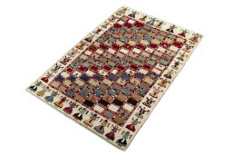 Corner detail of 2000s Persian Gabbeh rug showing border pattern and Wool pile