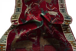 Corner detail of 2000s Persian Gabbeh rug showing border pattern and Wool pile