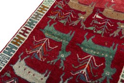 Backside of handmade 2000s Persian Gabbeh rug showing knot structure and weave density
