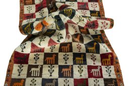 Corner detail of 2000s Persian Gabbeh rug showing border pattern and Wool pile