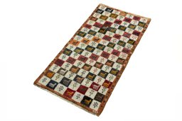 Corner detail of 2000s Persian Gabbeh rug showing border pattern and Wool pile