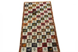 Surface texture of 2000s Persian Gabbeh rug with natural Wool and intricate pattern