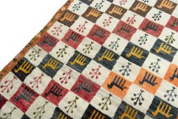 Backside of handmade 2000s Persian Gabbeh rug showing knot structure and weave density
