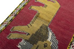 Backside of handmade 2000s Persian Gabbeh rug showing knot structure and weave density