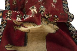 Corner detail of 2000s Persian Gabbeh rug showing border pattern and Wool pile