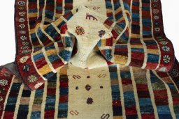 Corner detail of 2000s Persian Gabbeh rug showing border pattern and Wool pile