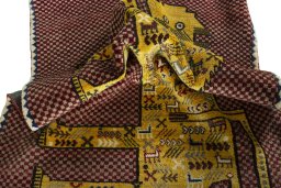 Corner detail of 2000s Persian Gabbeh rug showing border pattern and Wool pile