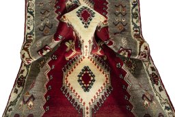 Corner detail of 2000s Persian Gabbeh rug showing border pattern and Wool pile