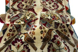 Corner detail of 2000s Persian Gabbeh rug showing border pattern and Wool pile