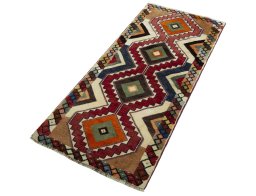 Corner detail of 2000s Persian Gabbeh rug showing border pattern and Wool pile