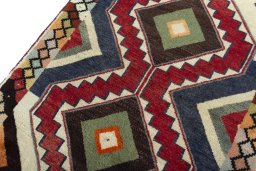Backside of handmade 2000s Persian Gabbeh rug showing knot structure and weave density