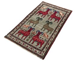 Corner detail of 2000s Persian Gabbeh rug showing border pattern and Wool pile