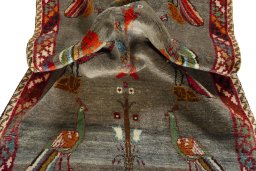 Corner detail of 2000s Persian Gabbeh rug showing border pattern and Wool pile