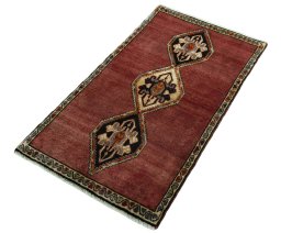 Corner detail of 2000s Persian Gabbeh rug showing border pattern and Wool pile
