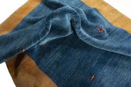 Corner detail of New Persian Gabbeh rug showing border pattern and Wool pile