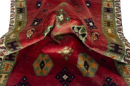 Corner detail of 2000s Persian Gabbeh rug showing border pattern and Wool pile