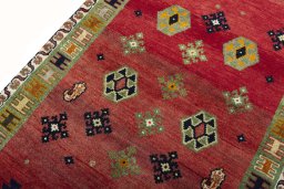 Backside of handmade 2000s Persian Gabbeh rug showing knot structure and weave density