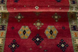Full view of 2000s Persian Gabbeh rug from Iran / Persia, 182 × 111 cm in Red tones