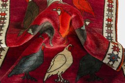 Corner detail of 2000s Persian Gabbeh rug showing border pattern and Wool pile