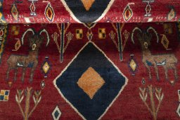 Corner detail of 2000s Persian Gabbeh rug showing border pattern and Wool pile