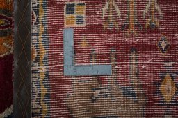 Surface texture of 2000s Persian Gabbeh rug with natural Wool and intricate pattern