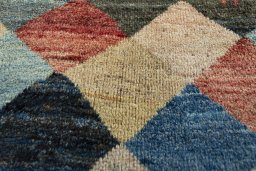 Surface texture of 2000s Persian Gabbeh rug with natural Wool and intricate pattern