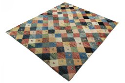 Corner detail of 2000s Persian Gabbeh rug showing border pattern and Wool pile