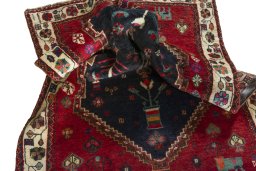 Corner detail of 2000s Persian Gabbeh rug showing border pattern and Wool pile