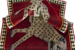 Corner detail of 2000s Persian Gabbeh rug showing border pattern and Wool pile