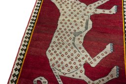 Backside of handmade 2000s Persian Gabbeh rug showing knot structure and weave density