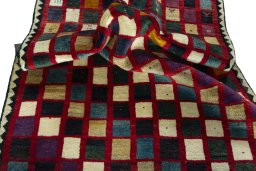 Corner detail of 2000s Persian Gabbeh rug showing border pattern and Wool pile